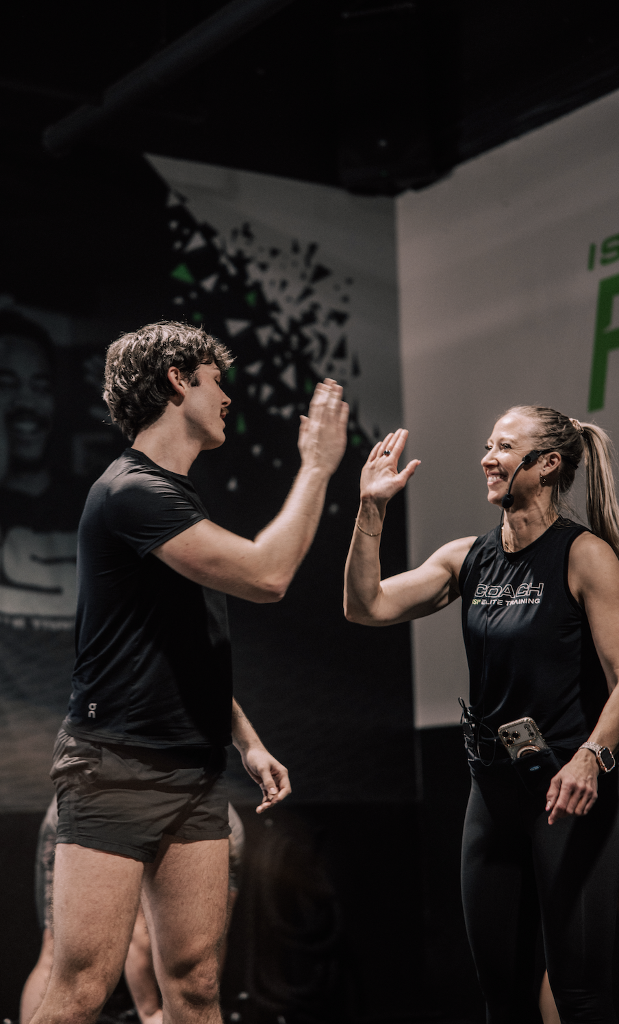 ISI Elite Training coach and athlete high-fiving mid-workout