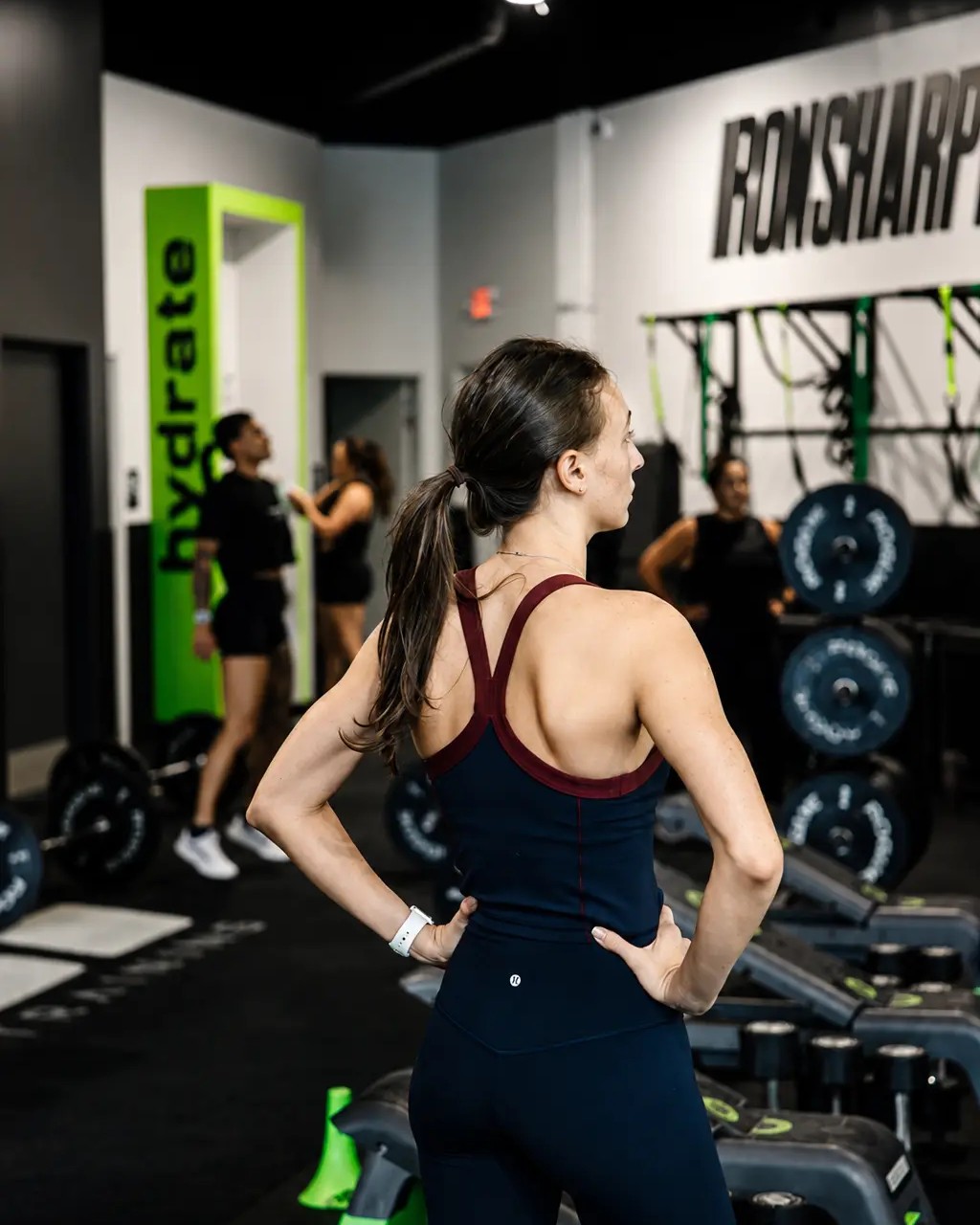 An athlete on the training floor under the IRON SHARPENS IRON wall